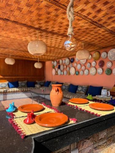 a kitchen with orange plates on a counter at Riad el wazania in Rabat