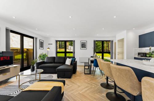 a living room with a couch and a table at Contemporary Leeds Apartment - Free Parking in Leeds