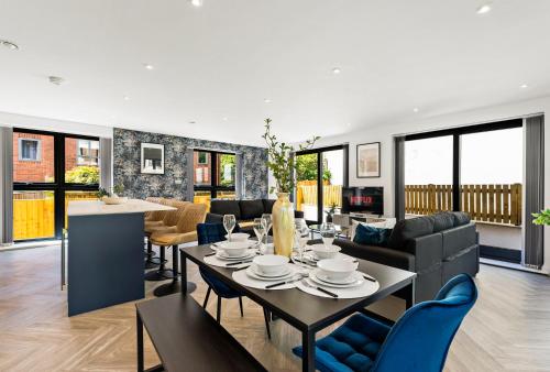a dining room and living room with a table and chairs at Contemporary Leeds Apartment - Free Parking in Leeds