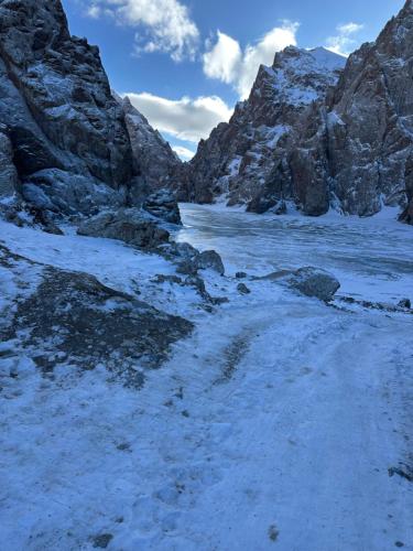 a snow covered mountain with a body of water at Кель-Суу Травел in Kol-Suu