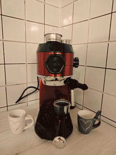 a coffee maker sitting on a counter with two cups at Claudia's Home La Suite in Pescia