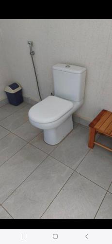 a white toilet in a bathroom with a broom at Halle Hotel - Lalibela in Lalībela
