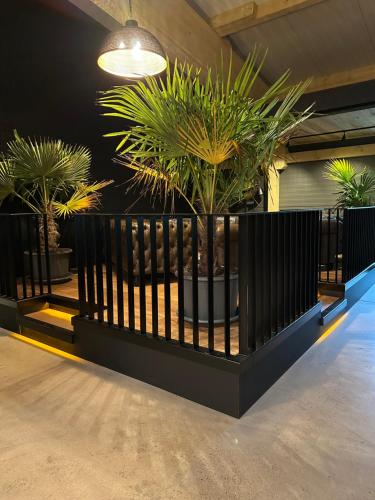 a black fence with potted plants in a room at Vareler Brauhaus-Hotel Varel Dangast in Varel
