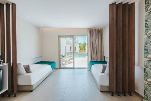 a hotel room with two beds and a pool at Atlantica Sungarden Park in Ayia Napa