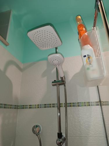 a bathroom with a shower with a shower head and a sink at Unique white stone Studio in Giovinazzo