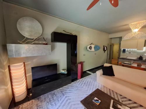 a living room with a couch and a fireplace at Casa Nice - centro Bogliasco in Bogliasco