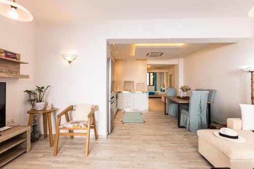 a living room with a kitchen and a dining room at Miraida Exclusive Residence in Almirida