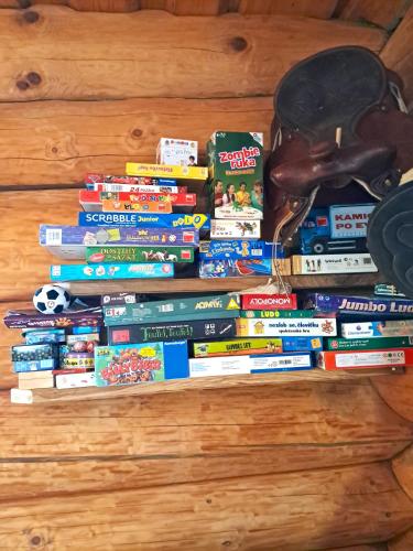 a stack of books sitting on a table at Srub Pohodář v Novohradských horách in Benešov nad Černou