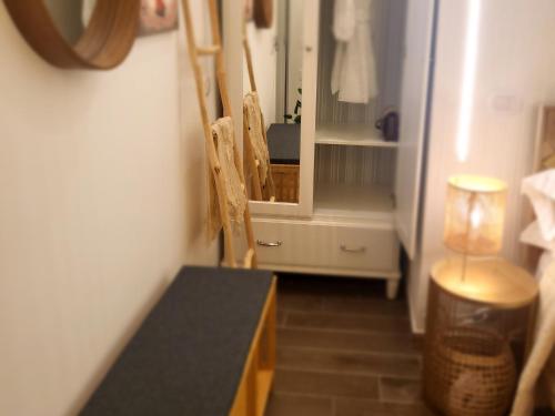a room with a table and a mirror and a refrigerator at Atrium in Castellammare del Golfo