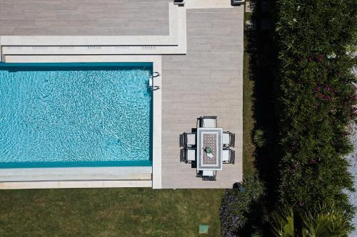 an overhead view of a swimming pool next to a house at Miraida Exclusive Residence in Almirida