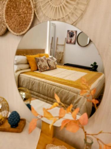 a mirror reflection of a bed in a bedroom at Atrium in Castellammare del Golfo
