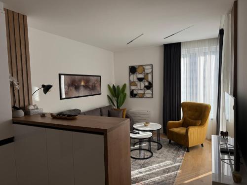a living room with a table and a chair at New apartment in Sarajevo
