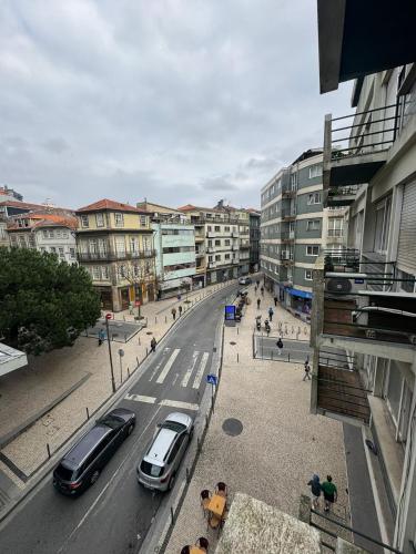 a city street with cars parked on the street at Dormitório Aliados in Porto