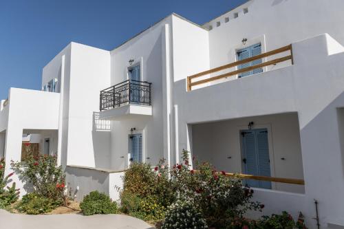 a white apartment building with balconies and plants at Marine Dream in Plaka