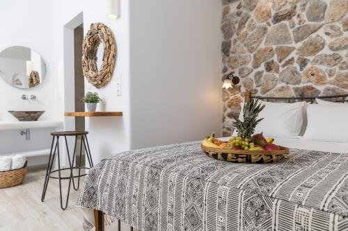 a bedroom with a bed with a bowl of fruit on a table at Marine Dream in Plaka