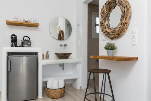 a bathroom with a sink and a mirror and stools at Marine Dream in Plaka