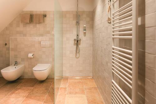 a bathroom with a toilet and a sink in it at Guesthouse Novak -Modern Barn Loft in Dvor