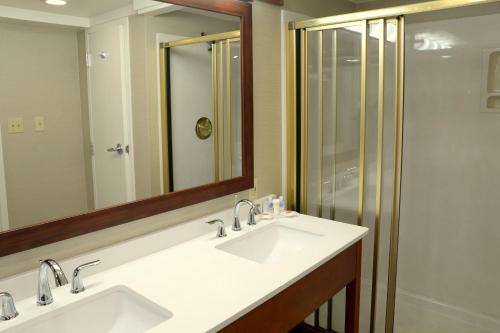 a bathroom with two sinks and a shower at Comfort Inn University Durham - Chapel Hill in Durham