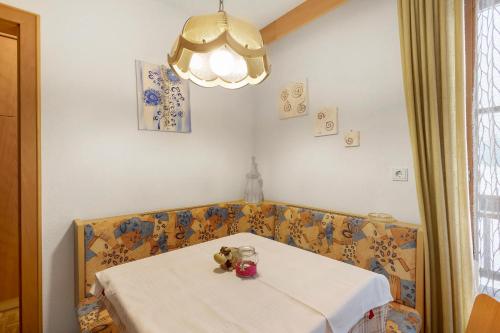 a table with a teddy bear sitting on top of it at Untersinnerhof Gsies in Valle Di Casies