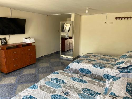 Una cama o camas en una habitación de Hospedaje Rodal
