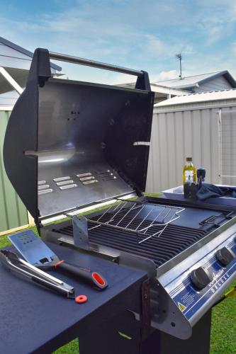a grill sitting on top of a picnic table at Paperbark Cottage in Callala Bay