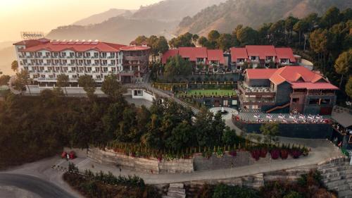 an aerial view of a resort with mountains in the background at Deventure Shimla Hills in Kandāghāt