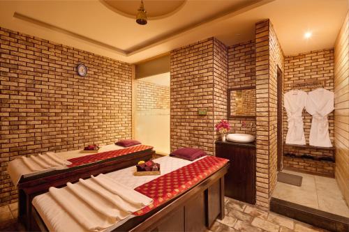 a room with two beds in a brick wall at Deventure Shimla Hills in Kandāghāt