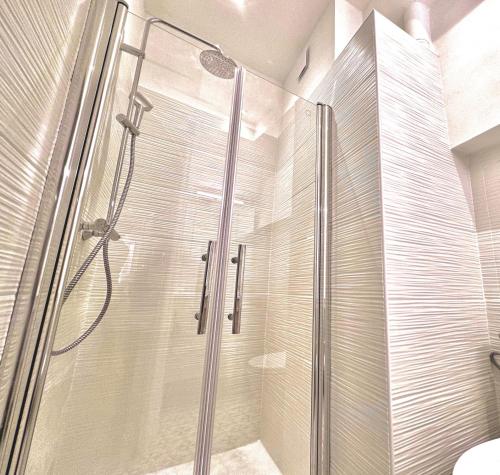 a shower with a glass door in a bathroom at ApartHotel Riviera - Maison de la Poissonnerie - Vieille Ville - Grand Appartement 3 piece AC - 5min de la Promenade des Anglais in Nice
