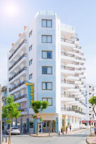 a tall white building on a city street at Hotel Orosol by Typic Hotels in San Antonio