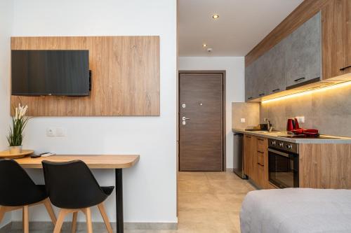 a kitchen with a table and chairs in a room at Ark Urban Living in Kozani