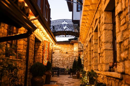 an alley in an old stone building with a balcony at White House Boutique Hotel & Restaurant - since 1999 in Berat