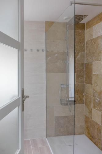 a shower with a glass door in a bathroom at - La Maison Authentique - 200 m du centre ville et proche d'Orléans in Jargeau