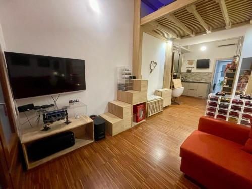 a living room with a large flat screen tv at Loft - Pioltello in Pioltello