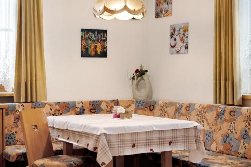 a table sitting on a couch with a white table cloth at Untersinnerhof Gsies in Valle Di Casies
