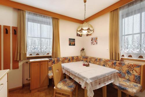 a dining room with a table and a couch at Untersinnerhof Gsies in Valle Di Casies
