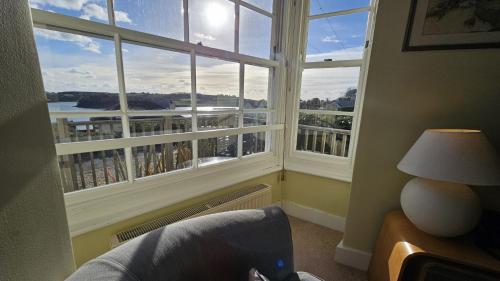 a room with a window with a view of a city at Charlies in Saint Mawes