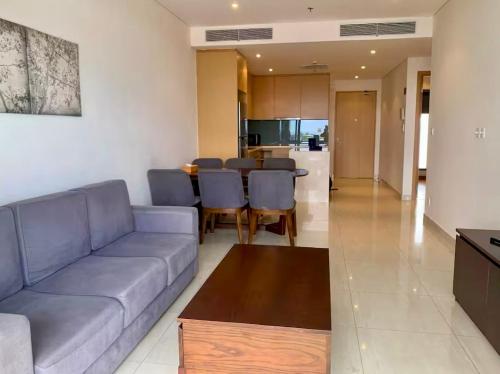 a living room with a couch and a table at 2BR Family Apartment Spectacular Scenery in Da Nang