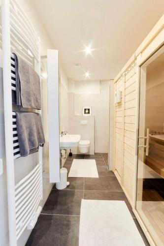 a bathroom with a white toilet and a sink at Treibgut in Norddeich