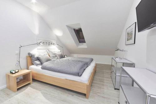 a bedroom with a bed in a small room at Treibgut in Norddeich