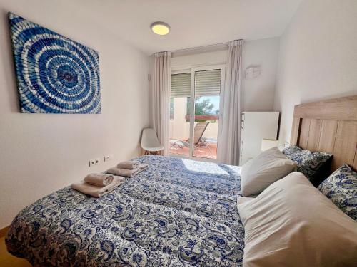 a bedroom with a bed with two towels on it at Condado de Alhama PENTHOUSE SV11 in Alhama de Murcia