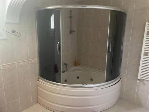 a bathroom with a shower and a bath tub at fuar VİLLA in Beylikduzu