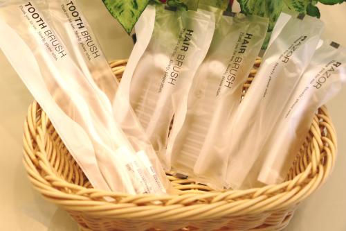 a basket filled with white plastic bags in it at Nest Hotel Matsuyama in Matsuyama