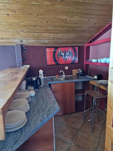 a kitchen with plates on a counter and a sink at Panorama in Gudauri