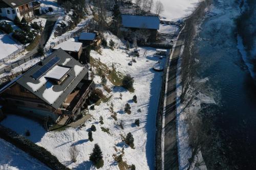 an aerial view of a house in the snow at Lodge am Fluss in Tamsweg