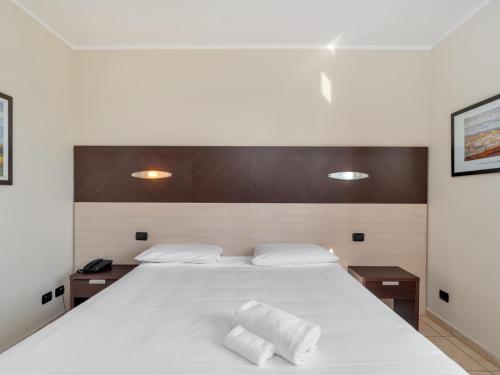 Postel nebo postele na pokoji v ubytování B&B HOTEL Settimo Torinese