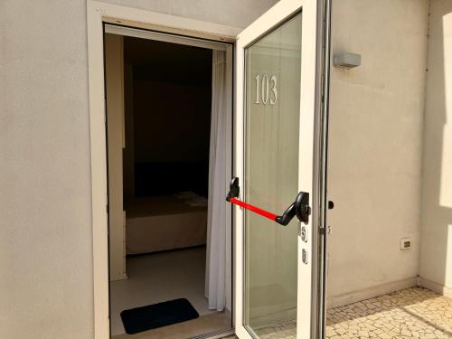 a door that is open with a red handle at Baia Sangiorgio Hotel & Beach Club in Bari