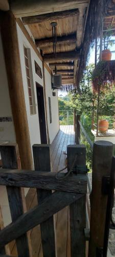 an outside view of a house with a wooden deck at Villa Girassol in Ilhabela