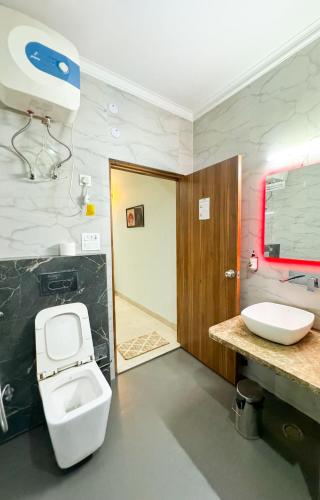 a bathroom with a toilet and a sink at Haven Hotel Sector 31,Gurugram in Gurgaon