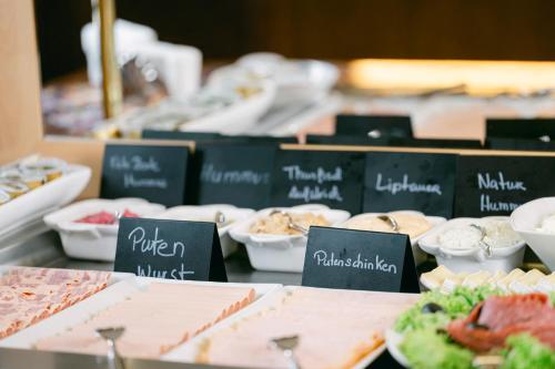 a buffet of different types of food on a table at Ambiance Hotel - Braunau - Simbach in Braunau am Inn
