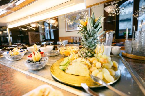 a table with a plate of food on a counter at Ambiance Hotel - Braunau - Simbach in Braunau am Inn